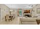 Living room boasts comfortable seating, tile floors, vaulted ceilings, and open concept with dining and kitchen at 1150 Jade East Ln, Kissimmee, FL 34744