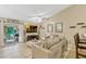 Comfortable living room featuring tile floors, vaulted ceilings, neutral colors, and access to the screened porch at 1150 Jade East Ln, Kissimmee, FL 34744