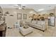 Cozy living room shows neutral colors, tile floors, vaulted ceilings, and comfortable seating arrangement at 1150 Jade East Ln, Kissimmee, FL 34744
