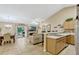 Inviting living space with tile flooring, ample natural light, comfortable seating, and adjacent kitchen area at 1150 Jade East Ln, Kissimmee, FL 34744