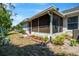 Screened-in back patio featuring garden space and view of the neighboring home at 1150 Jade East Ln, Kissimmee, FL 34744
