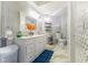 Bright bathroom featuring double vanity and a toilet with storage at 121 Lochness Ln, Kissimmee, FL 34743