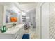 Bright bathroom features double vanity and a toilet with storage at 121 Lochness Ln, Kissimmee, FL 34743
