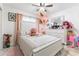 Bright bedroom featuring a large bed, dresser and ceiling fan at 121 Lochness Ln, Kissimmee, FL 34743