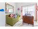 bedroom with light filled window, cute couch, and modern desk with plenty of light at 121 Lochness Ln, Kissimmee, FL 34743