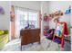 bedroom featuring a bright light filled window, modern desk, and decorated with toys at 121 Lochness Ln, Kissimmee, FL 34743