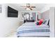 Bright primary bedroom featuring a large mirror, a large bed and a modern ceiling fan at 121 Lochness Ln, Kissimmee, FL 34743