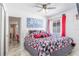 Bright bedroom featuring a ceiling fan, tile floor, and modern decor at 121 Lochness Ln, Kissimmee, FL 34743