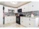 Kitchen featuring white cabinets, black appliances, and tile backsplash at 121 Lochness Ln, Kissimmee, FL 34743