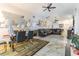 Open-concept living and dining area with tile flooring, elegant decor, and vaulted ceilings at 121 Lochness Ln, Kissimmee, FL 34743