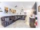 Spacious living room with a large leather sectional, tile floors, and ceiling fan at 121 Lochness Ln, Kissimmee, FL 34743