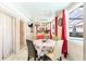 Bright sunroom with dining area, leading to a view of the outdoor pool and kitchen at 121 Lochness Ln, Kissimmee, FL 34743