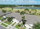 Beautiful aerial view of townhomes with lush landscaping, lake, and golf course at 127 Club Villas Ln, Kissimmee, FL 34744