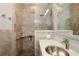 Bathroom featuring a glass shower, accessible features, and modern vanity at 127 Club Villas Ln, Kissimmee, FL 34744