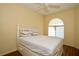Bedroom with a ceiling fan, wood flooring, and arched window at 127 Club Villas Ln, Kissimmee, FL 34744
