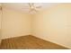 Neutral bedroom featuring wood-look floors and a ceiling fan at 127 Club Villas Ln, Kissimmee, FL 34744
