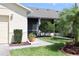 View of side of home with a screened in porch and flower pots at 127 Club Villas Ln, Kissimmee, FL 34744