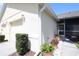 View of side of home with a screened in porch and flower pots at 127 Club Villas Ln, Kissimmee, FL 34744