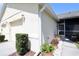 View of side of home with a screened in porch and flower pots at 127 Club Villas Ln, Kissimmee, FL 34744