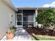 Exterior with landscaping, a screened porch, and walkway with potted plants in natural light at 127 Club Villas Ln, Kissimmee, FL 34744