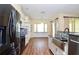 Bright kitchen boasts stainless steel appliances, granite countertops, and breakfast nook with large windows at 127 Club Villas Ln, Kissimmee, FL 34744