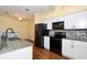 An eat-in kitchen featuring sleek, modern appliances and designer accents at 127 Club Villas Ln, Kissimmee, FL 34744