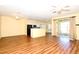 A spacious living room with laminate wood flooring and an open-concept view of the kitchen at 127 Club Villas Ln, Kissimmee, FL 34744