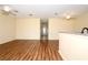 Spacious living room with laminate wood flooring, a hall, and a view of the foyer at 127 Club Villas Ln, Kissimmee, FL 34744