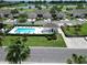Community pool with surrounding homes, landscaping, and lake views in a picturesque setting at 127 Club Villas Ln, Kissimmee, FL 34744
