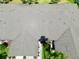 Birds-eye view of a roof with dormers and manicured landscaping below at 127 Club Villas Ln, Kissimmee, FL 34744