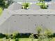 Aerial view of neighborhood roofs and greenery showcasing well-maintained exteriors at 127 Club Villas Ln, Kissimmee, FL 34744