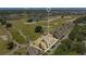 Aerial view of a townhouse community with a golf course and a lake in the background at 1311 Seven Eagles Ct # 202, Reunion, FL 34747