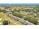 Aerial view featuring a community bordering a golf course, showcasing lush greenery and inviting residences at 1311 Seven Eagles Ct # 202, Reunion, FL 34747