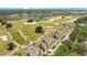 Aerial view showcasing the homes situated alongside a lush golf course and a serene pond at 1311 Seven Eagles Ct # 202, Reunion, FL 34747