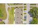 Aerial view of a community, highlighting well-kept green spaces, a golf course, and convenient parking at 1311 Seven Eagles Ct # 202, Reunion, FL 34747