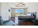 Bright bedroom with hardwood floors, ceiling fan, and scenic view from the large windows at 1311 Seven Eagles Ct # 202, Reunion, FL 34747