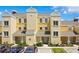 Beautiful townhouse exterior with yellow siding and white trim, inviting curb appeal and well-maintained landscaping at 1311 Seven Eagles Ct # 202, Reunion, FL 34747