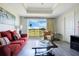 Inviting living room with contemporary furnishings, neutral walls, and a scenic outdoor view through the window at 1311 Seven Eagles Ct # 202, Reunion, FL 34747