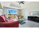 Bright living room featuring modern decor, large windows with golf course view, and comfortable seating at 1311 Seven Eagles Ct # 202, Reunion, FL 34747