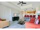 Spacious living area flowing into the kitchen, featuring hardwood floors, and comfortable furniture at 1311 Seven Eagles Ct # 202, Reunion, FL 34747