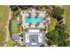 Aerial shot of a community pool with palm trees and plenty of lounge chairs at 1311 Seven Eagles Ct # 202, Reunion, FL 34747