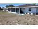 A backyard with a chain link fence and a screened lanai offers privacy and comfort at 15106 Sw 38Th Cir, Ocala, FL 34473