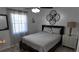 Cozy bedroom featuring modern fan, neutral decor, and decorative wall art at 15106 Sw 38Th Cir, Ocala, FL 34473