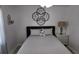 Cozy bedroom with soft lighting, decorative wall mirror, and neutral decor at 15106 Sw 38Th Cir, Ocala, FL 34473