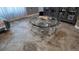 Modern coffee table with glass shelves sitting on travertine tile at 15106 Sw 38Th Cir, Ocala, FL 34473