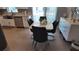 Bright dining area with a white table, black chairs, and adjacent kitchen with modern stainless appliances at 15106 Sw 38Th Cir, Ocala, FL 34473
