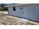 Exterior view of the home's side with a back door and a well-kept yard at 15106 Sw 38Th Cir, Ocala, FL 34473