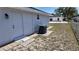 Exterior view of the home's side with a back door, an AC unit, and a fenced yard at 15106 Sw 38Th Cir, Ocala, FL 34473