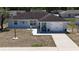 Elevated view of a house, emphasizing the front yard, entrance, and attached garage at 15106 Sw 38Th Cir, Ocala, FL 34473