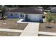 Up-close aerial picture of a residence displaying its driveway, garage, and yard at 15106 Sw 38Th Cir, Ocala, FL 34473
